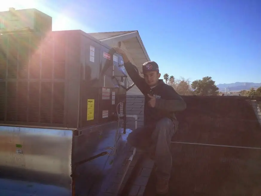 HVAC technician performing HVAC Inspection on a rooftop unit in Lake Dallas